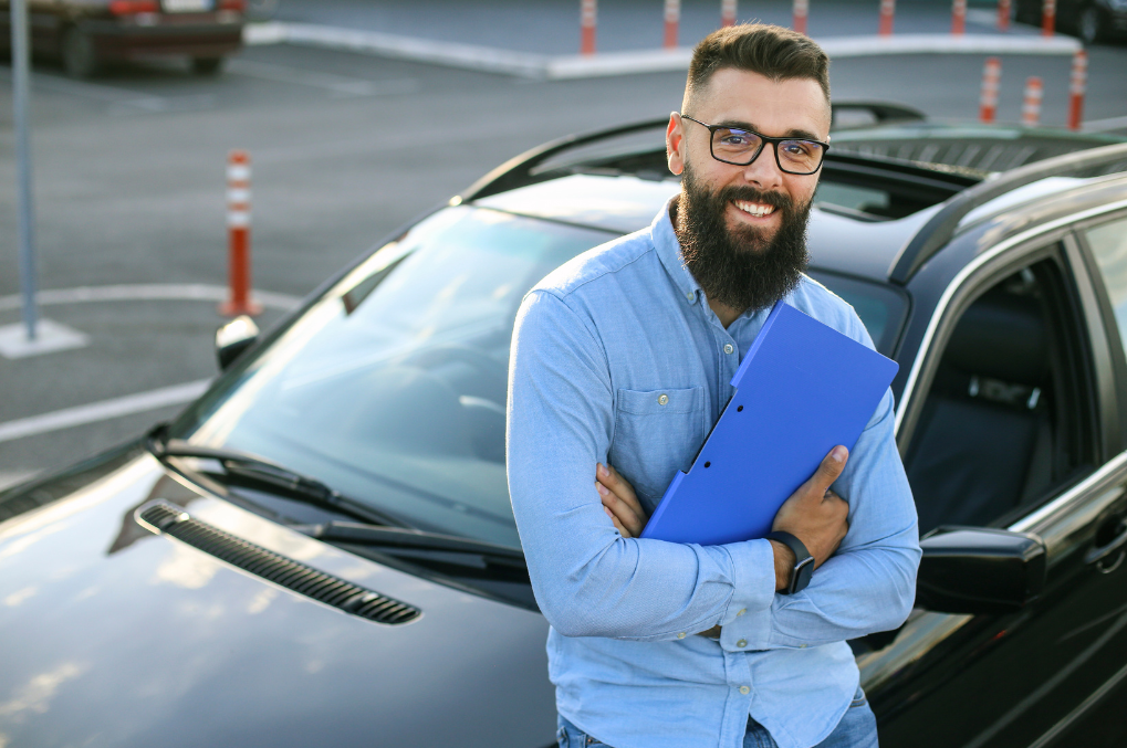 Newly qualified driving instructor holding a pass certificate in Sutton, trained by Purple Driving.