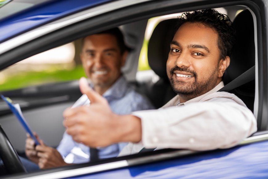 A happy pupil with Purple driving instructor in car while training
