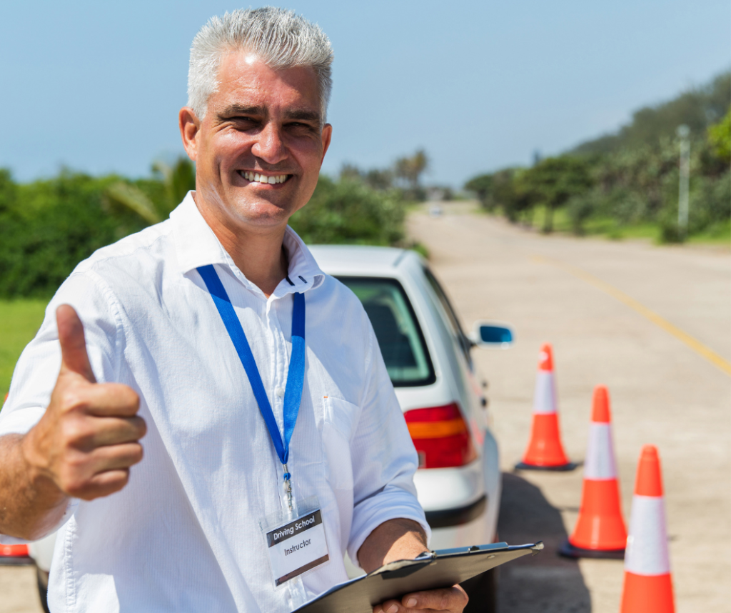 Newly qualified driving instructor holding a pass certificate in Sutton, trained by Purple Driving.