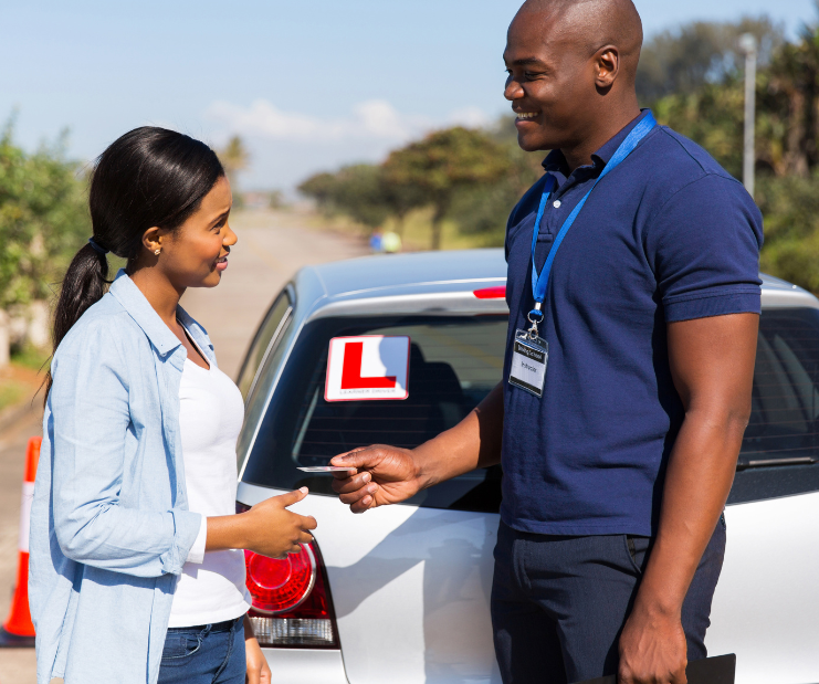 Purple Driving School instructor greeting a nervous beginner for their first driving lesson in Croydon